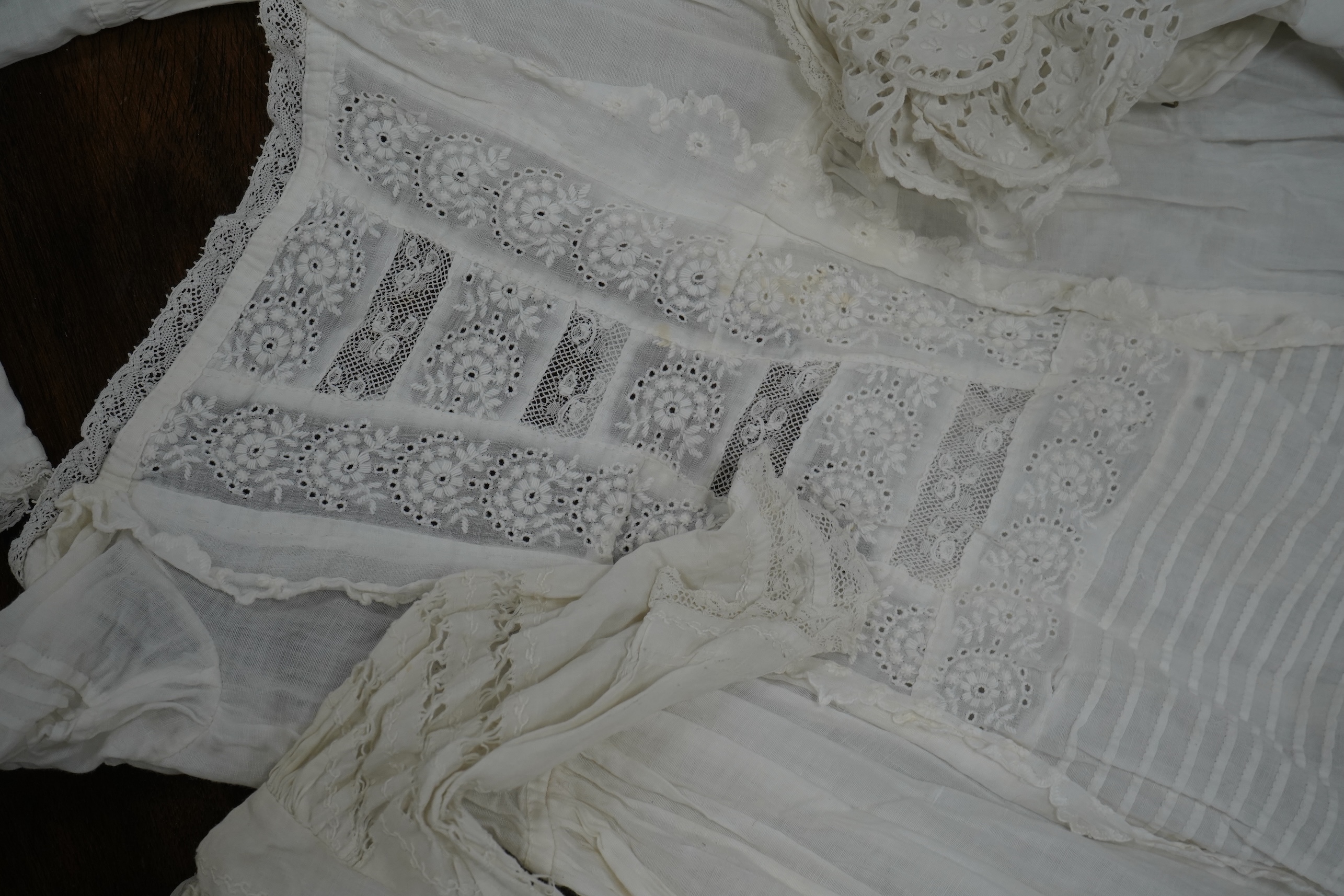 Five Victorian white worked fine cotton and lawn baby’s christening gowns. mostly worked with embroidery anglaise, feather stitching, tucking, drawn thread work and lace edging, longest 41cm. Condition - in good conditio